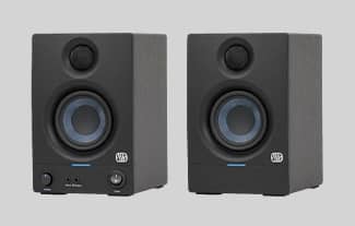 A pair of black studio monitors sitting side-by-side.
