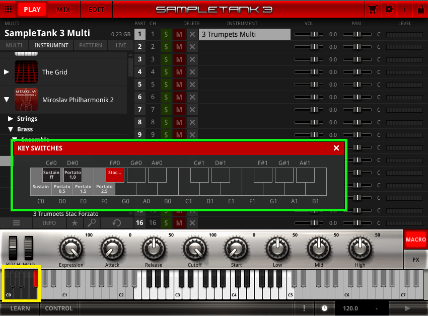 Small MIDI Controller Piano on Yellow Background with Cell Phone